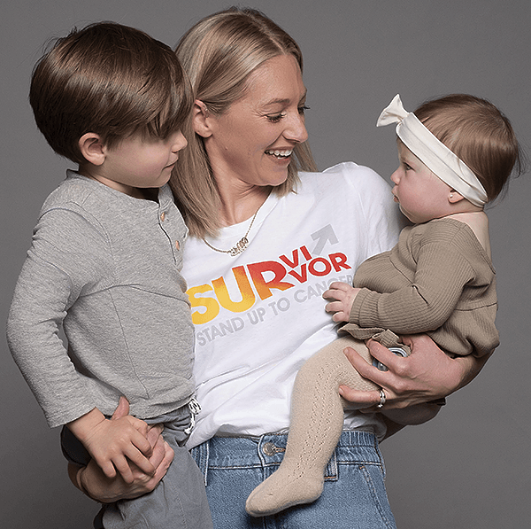 Kelly is holding her two kids because of cancer funded research.
